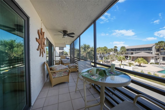 balcony featuring a residential view and a ceiling fan