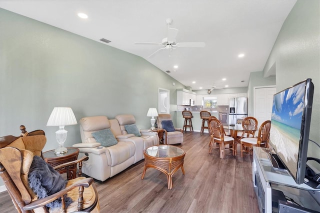 living area with visible vents, ceiling fan, lofted ceiling, recessed lighting, and wood finished floors