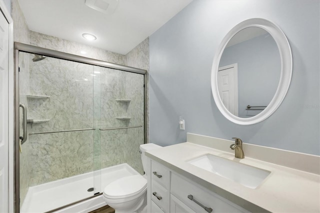 full bathroom with a shower stall, toilet, and vanity