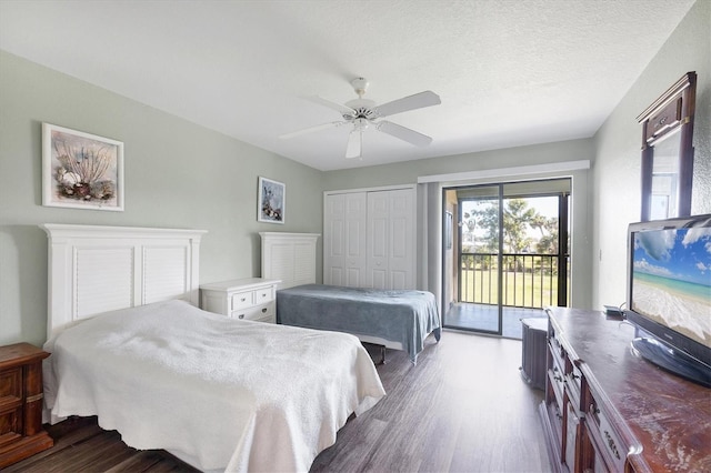 bedroom featuring a closet, ceiling fan, dark wood-style flooring, and access to outside