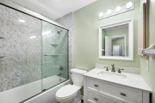 bathroom with combined bath / shower with glass door, toilet, and vanity