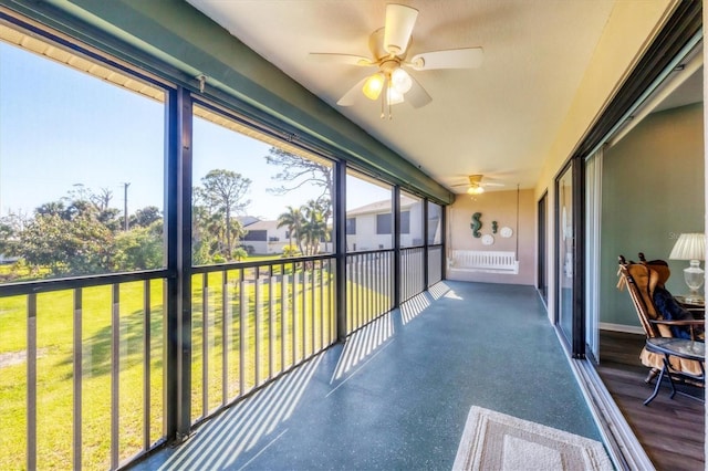 sunroom featuring a ceiling fan