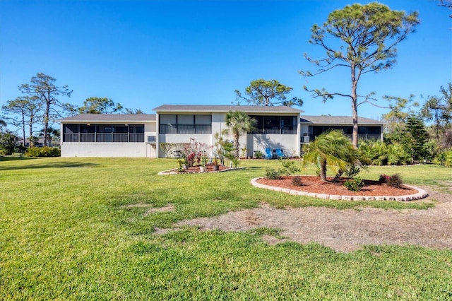 view of front of home featuring stucco siding, a front lawn, and a sunroom