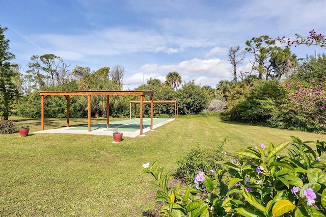 view of play area featuring shuffleboard and a yard