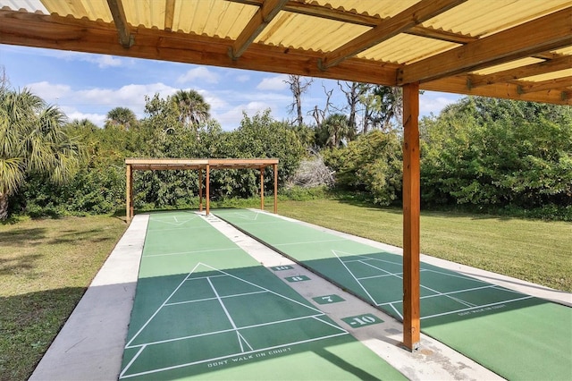 surrounding community with shuffleboard and a lawn