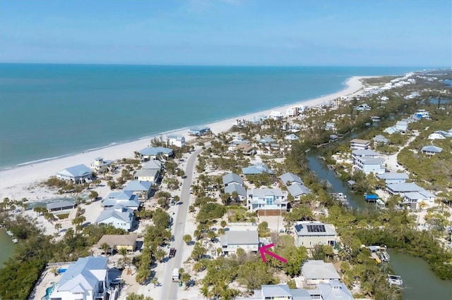 birds eye view of property with a water view, a residential view, and a view of the beach