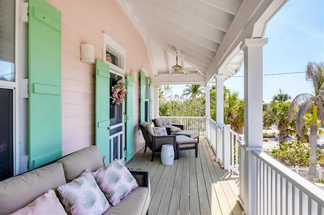 deck with ceiling fan and an outdoor living space