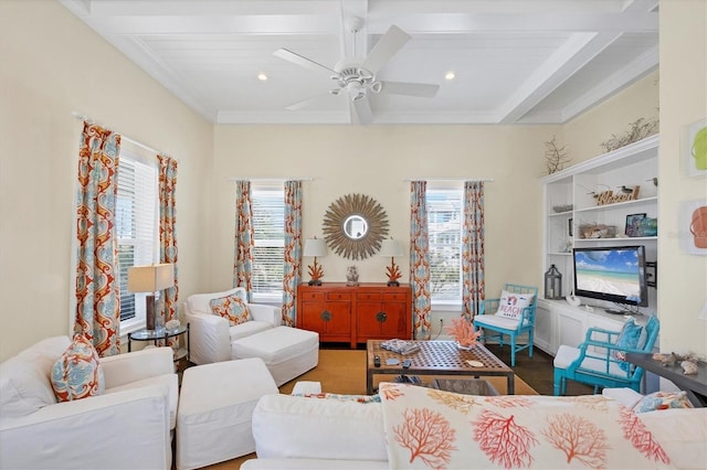 living area with ceiling fan, ornamental molding, beamed ceiling, and recessed lighting