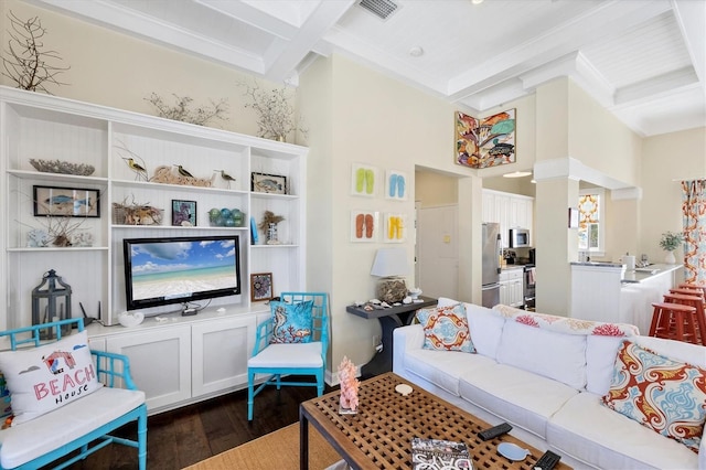 living area featuring coffered ceiling, visible vents, dark wood finished floors, and beamed ceiling