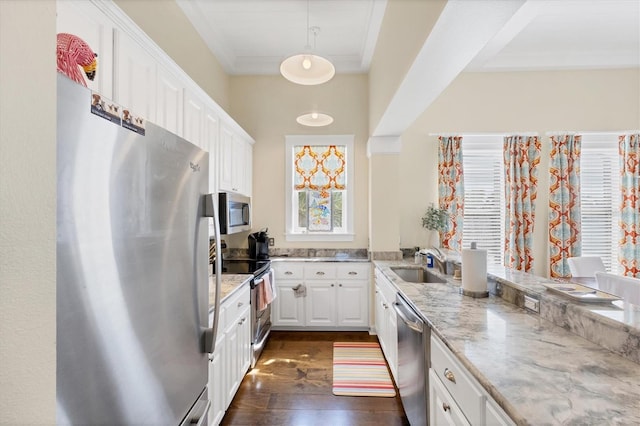 kitchen featuring stainless steel appliances, white cabinets, a sink, and ornamental molding