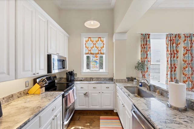 kitchen featuring light stone counters, a sink, white cabinets, appliances with stainless steel finishes, and dark wood finished floors