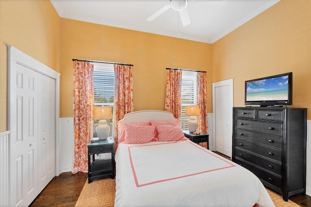 bedroom with a ceiling fan, ornamental molding, wood finished floors, and wainscoting