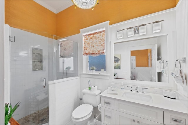 bathroom with toilet, ornamental molding, tiled shower, and vanity