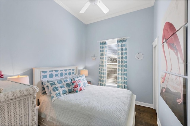 bedroom featuring baseboards, wood finished floors, a ceiling fan, and crown molding