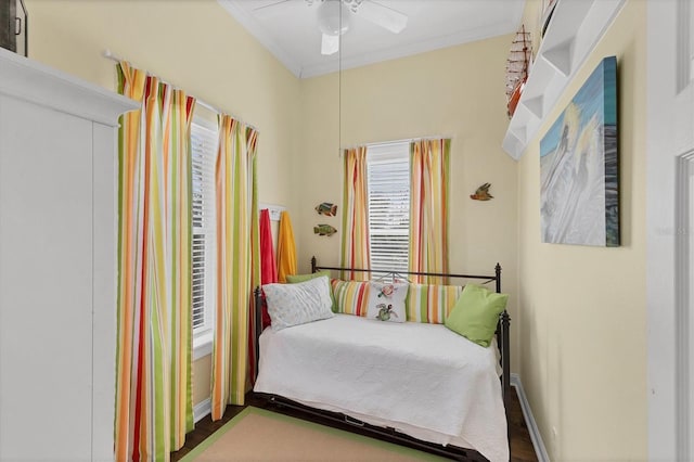 bedroom featuring ceiling fan, baseboards, and crown molding