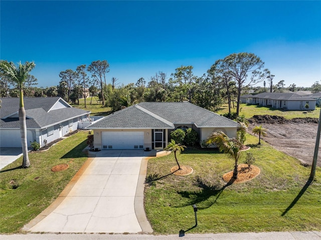 ranch-style home featuring an attached garage, concrete driveway, a front yard, and a shingled roof