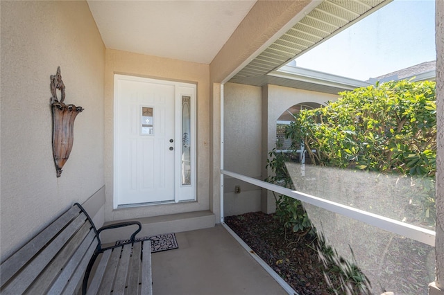 doorway to property with stucco siding