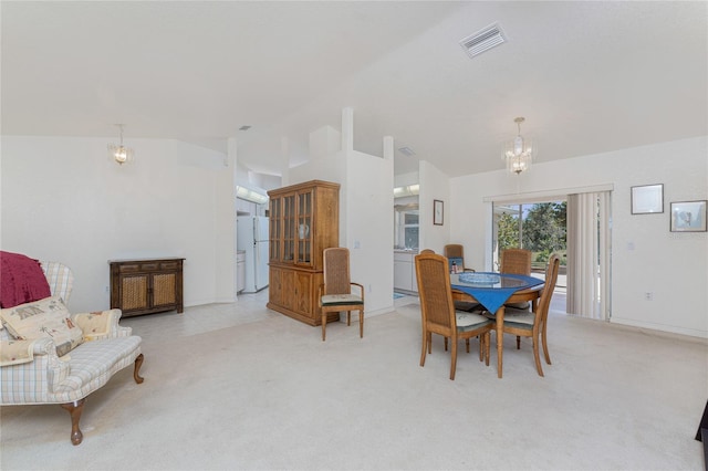 dining space with visible vents, light colored carpet, a chandelier, and vaulted ceiling