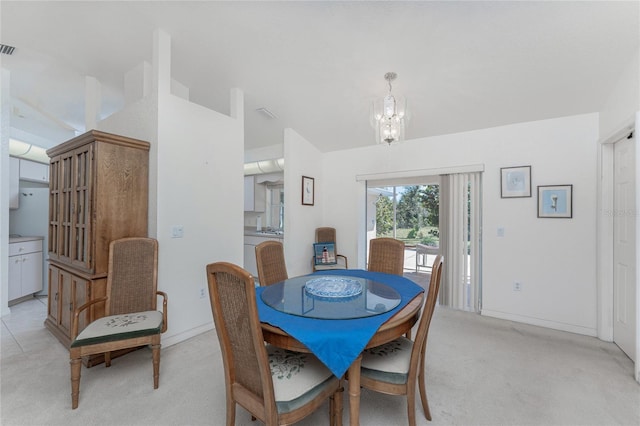 dining space featuring an inviting chandelier, light colored carpet, baseboards, and visible vents