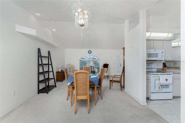 dining space with a chandelier, baseboards, and vaulted ceiling