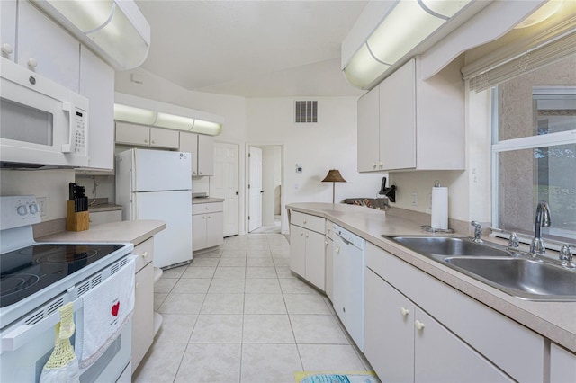 kitchen with visible vents, light countertops, white appliances, white cabinetry, and a sink