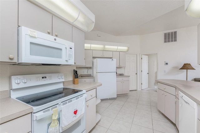 kitchen featuring light tile patterned floors, visible vents, white appliances, and light countertops