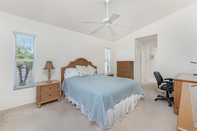 bedroom with vaulted ceiling, multiple windows, a ceiling fan, and light carpet