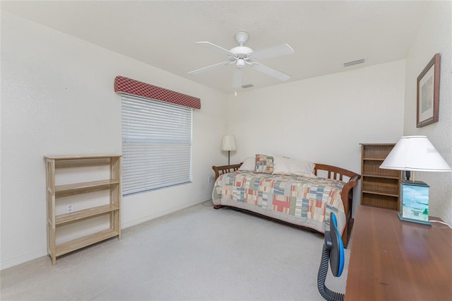 carpeted bedroom with visible vents and a ceiling fan