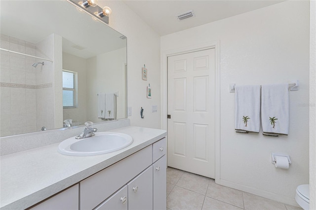 full bathroom featuring visible vents, toilet, tile patterned flooring, tiled shower, and vanity