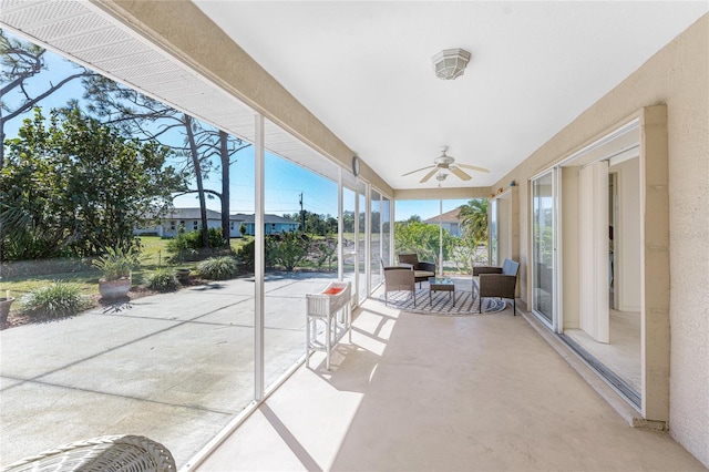 unfurnished sunroom with a ceiling fan