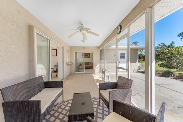 sunroom with a ceiling fan