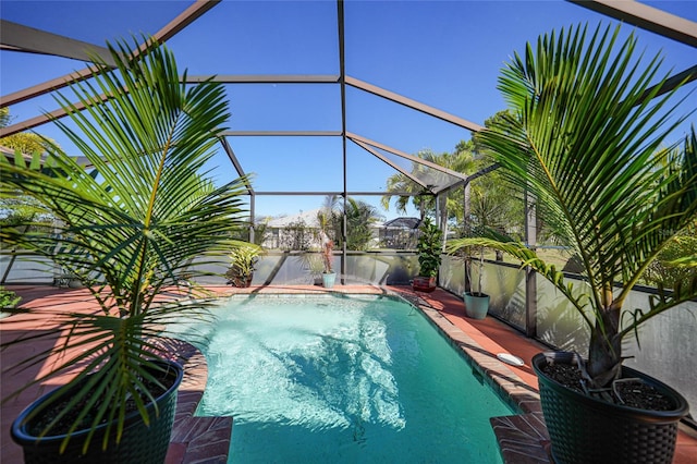 view of swimming pool featuring a lanai, a fenced in pool, and a patio area