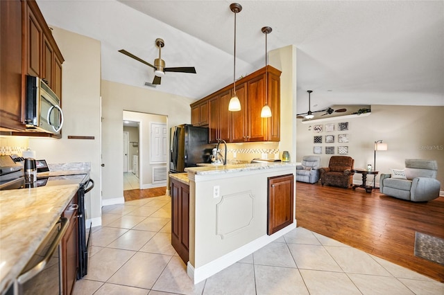 kitchen featuring light tile patterned floors, black appliances, open floor plan, and a ceiling fan