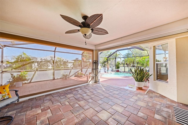 unfurnished sunroom with visible vents and ceiling fan