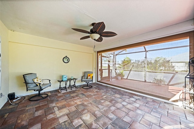 sunroom / solarium featuring ceiling fan