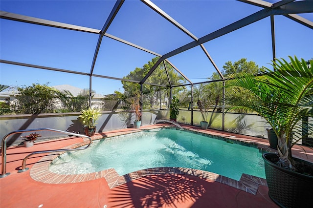 pool featuring glass enclosure and a patio