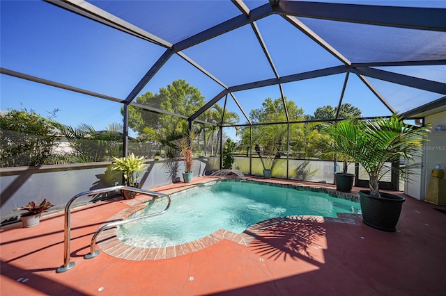 pool with glass enclosure and a patio