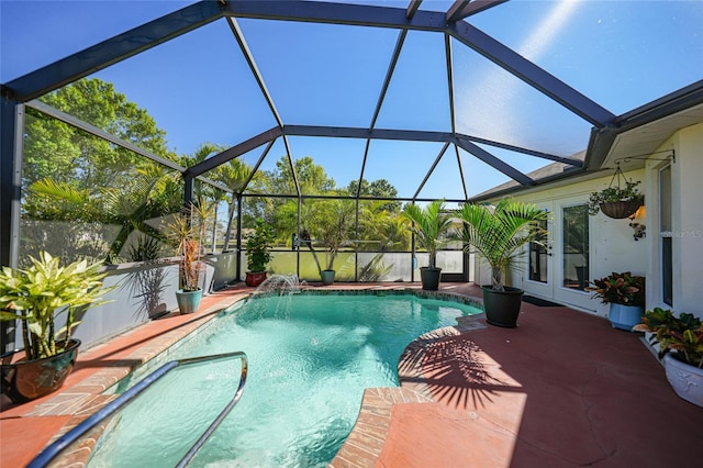 outdoor pool featuring glass enclosure, a patio area, and french doors