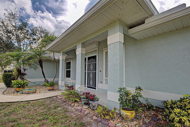 property entrance with stucco siding