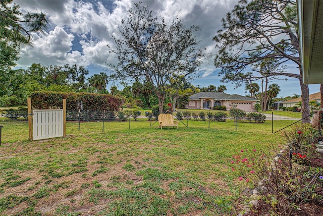 view of yard featuring a garage and fence