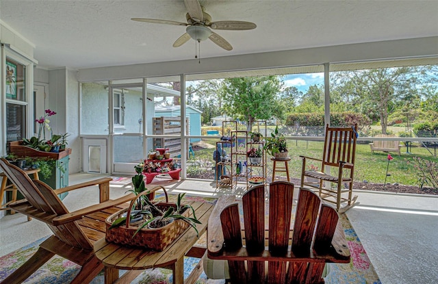 sunroom / solarium with a ceiling fan