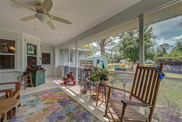 sunroom with a ceiling fan