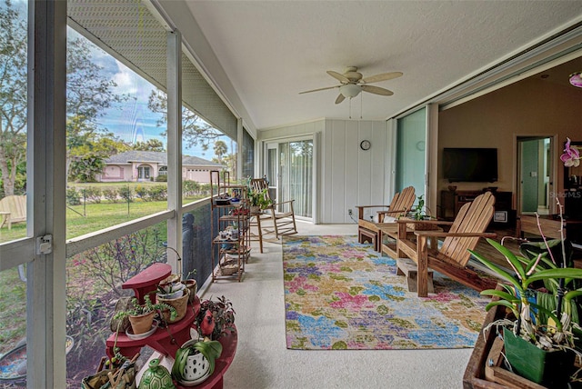 sunroom / solarium featuring a ceiling fan and vaulted ceiling