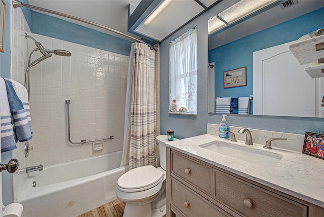 full bath with shower / tub combo, visible vents, toilet, wood finished floors, and vanity