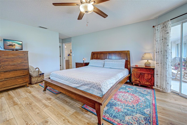 bedroom featuring access to exterior, visible vents, multiple windows, and wood finished floors