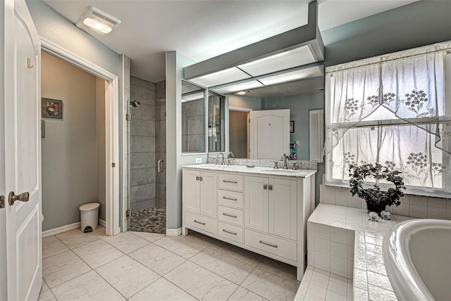 full bathroom featuring a garden tub, a sink, a shower stall, and double vanity