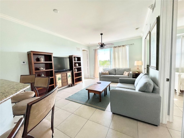 living area featuring light tile patterned floors, visible vents, crown molding, and a ceiling fan