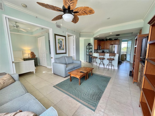 living room featuring crown molding, light tile patterned floors, a ceiling fan, and visible vents