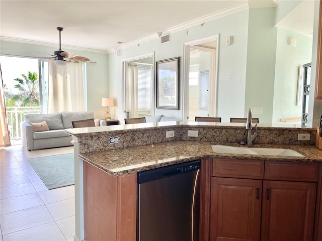 kitchen featuring open floor plan, light tile patterned floors, dark stone countertops, stainless steel dishwasher, and a sink