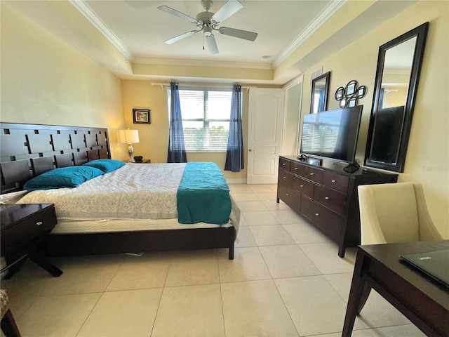 bedroom featuring light tile patterned floors, a tray ceiling, ornamental molding, and a ceiling fan